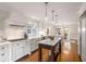 Bright kitchen with white cabinets, a center island, stainless steel appliances, and hardwood floors at 1041 Standard Ne Dr, Brookhaven, GA 30319