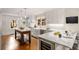Gourmet kitchen featuring white cabinetry, marble countertops, stainless steel appliances, and hardwood floors at 1041 Standard Ne Dr, Brookhaven, GA 30319