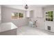 Clean laundry room featuring white cabinets, a light blue utility sink, a door to the outside, and a window at 1041 Standard Ne Dr, Brookhaven, GA 30319