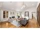 Bright living room features a fireplace, hardwood floors, large windows, and access to the backyard at 1041 Standard Ne Dr, Brookhaven, GA 30319