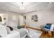 Spacious main bedroom featuring trey ceilings, hardwood floors, a stylish chandelier, and plenty of natural light at 1041 Standard Ne Dr, Brookhaven, GA 30319
