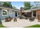 Outdoor stone patio with comfortable seating, brick chimney, and nice backyard at 1041 Standard Ne Dr, Brookhaven, GA 30319