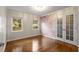 Neutral room with hardwood floors, decorative French doors, and natural light at 1041 Standard Ne Dr, Brookhaven, GA 30319