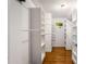 Bright walk-in closet with custom shelving and hardwood floors at 1041 Standard Ne Dr, Brookhaven, GA 30319