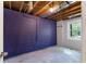 Unfinished basement showing painted walls, ceiling beams, and a window at 128 Reynolds Bridge Rd, Kingston, GA 30145