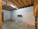 Unfinished basement with painted brick walls, open ceiling, and concrete floor at 128 Reynolds Bridge Rd, Kingston, GA 30145