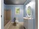 Bathroom with blue walls, a modern vanity, an oval mirror, and a shower-tub combination at 128 Reynolds Bridge Rd, Kingston, GA 30145