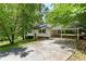 Charming single-story home with a red front door, carport, and a spacious driveway at 128 Reynolds Bridge Rd, Kingston, GA 30145