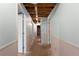 Unfinished hallway with open ceiling, paneled walls, and doors to other rooms at 128 Reynolds Bridge Rd, Kingston, GA 30145
