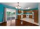 Inviting kitchen with wood cabinets, white appliances, and easy access to the outdoor deck at 128 Reynolds Bridge Rd, Kingston, GA 30145