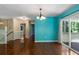 Open-concept living room with hardwood floors, a chandelier, blue walls, and sliding doors to the deck at 128 Reynolds Bridge Rd, Kingston, GA 30145