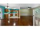Open-concept living space featuring hardwood floors, a kitchen with oak cabinets, and natural light from the windows at 128 Reynolds Bridge Rd, Kingston, GA 30145