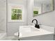 A bathroom features a sleek vanity, modern fixtures, and a bright window view at 163 Oakcliff Ct, South Fulton, GA 30331