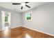 Bedroom with hardwood floors, ceiling fan, and a view of the lush green outdoors at 163 Oakcliff Ct, South Fulton, GA 30331