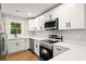 Modern kitchen with stainless steel appliances, white cabinetry, and ample counter space at 163 Oakcliff Ct, South Fulton, GA 30331