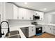 Stylish kitchen features stainless steel appliances, white cabinets, and plenty of counter space at 163 Oakcliff Ct, South Fulton, GA 30331