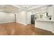 Open-concept living area connecting to modern kitchen, featuring hardwood floors and neutral paint at 163 Oakcliff Ct, South Fulton, GA 30331