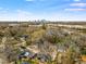 An aerial view of the neighborhood showcases the surrounding mature trees and distant city skyline at 23 Gould Se St, Atlanta, GA 30315