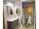 Cozy bathroom featuring stone floors, vanity with sink and shower at 23 Gould Se St, Atlanta, GA 30315