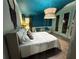 Comfortable bedroom featuring a queen bed, blue ceiling, and doors leading outside at 23 Gould Se St, Atlanta, GA 30315
