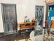 Bright dining room with a glass table, and rustic doors and accents at 23 Gould Se St, Atlanta, GA 30315