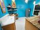 Kitchen showcasing blue walls, an open shelf with décor, and modern appliances at 23 Gould Se St, Atlanta, GA 30315