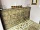 Rustic living area featuring stone floors, and two vintage wooden cabinets at 23 Gould Se St, Atlanta, GA 30315