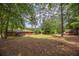 Expansive backyard with shade trees and outbuilding at 3761 Lindley Cir, Powder Springs, GA 30127