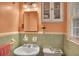 Bathroom with a sink, toilet, and mirrored medicine cabinet at 3761 Lindley Cir, Powder Springs, GA 30127