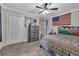 Bedroom featuring a ceiling fan, closet doors and a dresser at 3761 Lindley Cir, Powder Springs, GA 30127