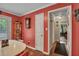 Cozy dining area with red walls, a retro table and chairs, and hardwood floors at 3761 Lindley Cir, Powder Springs, GA 30127
