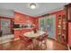 Bright dining area with stylish red accents and French doors to the outside, perfect for entertaining at 3761 Lindley Cir, Powder Springs, GA 30127