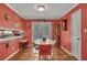 Bright dining area with stylish red accents, French doors to the outside, and cozy eating nook at 3761 Lindley Cir, Powder Springs, GA 30127