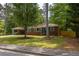 Charming brick ranch home featuring turquoise shutters and a well-maintained front yard at 3761 Lindley Cir, Powder Springs, GA 30127