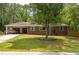 Charming brick ranch home featuring a covered carport and a well-maintained front yard at 3761 Lindley Cir, Powder Springs, GA 30127