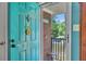 Inviting front door with a vibrant turquoise finish, complete with a 'Welcome' sunflower at 3761 Lindley Cir, Powder Springs, GA 30127