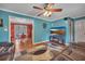 Cozy living room featuring an open layout, adjacent dining area, and modern entertainment center at 3761 Lindley Cir, Powder Springs, GA 30127