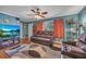 Comfortable living room featuring leather reclining sofas, large window, and modern decor at 3761 Lindley Cir, Powder Springs, GA 30127