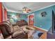 Comfortable living room featuring leather reclining sofas, hardwood floors, and views into the kitchen at 3761 Lindley Cir, Powder Springs, GA 30127