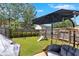 Lush backyard with a playset, shade, and privacy fence at 635 Oakside Pl, Acworth, GA 30102