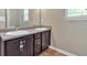 Bathroom vanity with double sinks, wood cabinets, and modern fixtures at 635 Oakside Pl, Acworth, GA 30102