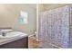 Bright bathroom featuring a double sink vanity and a shower with a patterned curtain at 635 Oakside Pl, Acworth, GA 30102