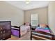 Cozy bedroom furnished with two twin beds, a dresser, and soft neutral carpet at 635 Oakside Pl, Acworth, GA 30102