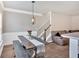 Open dining area featuring a modern light fixture and dark wood dining table with bench seating at 635 Oakside Pl, Acworth, GA 30102