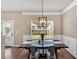 Cozy dining area with a modern light fixture, a rustic wooden table, and bright natural light at 635 Oakside Pl, Acworth, GA 30102