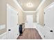 Bright entryway featuring hardwood floors, neutral paint, modern storage cabinet, and white trim at 635 Oakside Pl, Acworth, GA 30102