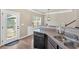 Kitchen featuring stainless steel dishwasher and sink, with view of back yard through window at 635 Oakside Pl, Acworth, GA 30102