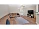 Open living room with hardwood floors, neutral walls, and a large sectional sofa for relaxing at 635 Oakside Pl, Acworth, GA 30102