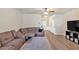Spacious living room with plush sofa, neutral tones, and modern décor at 635 Oakside Pl, Acworth, GA 30102