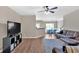 Cozy living room featuring an open floor plan, hardwood floors, ceiling fan, and comfortable seating at 635 Oakside Pl, Acworth, GA 30102